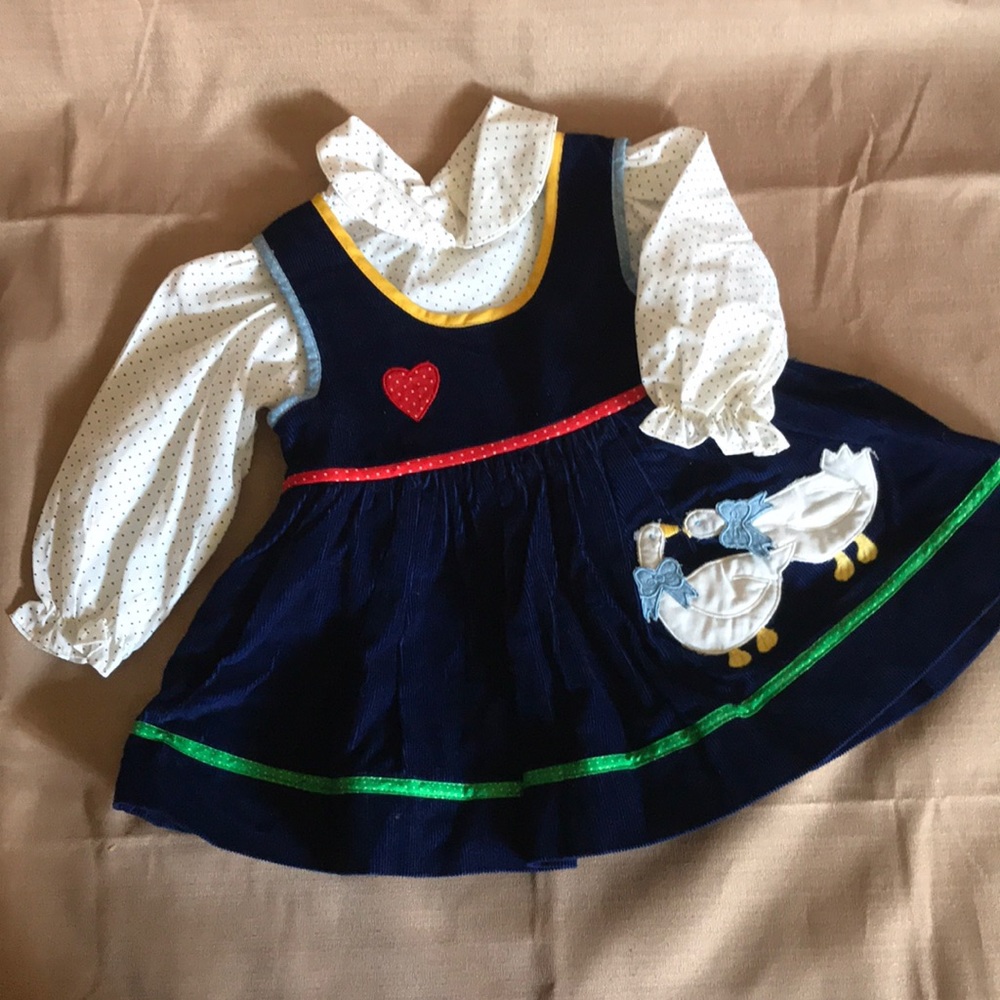 Girl’s navy corduroy jumper and white blouse.